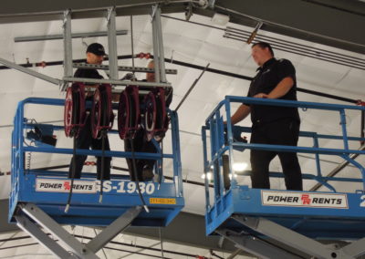 Northwest Pump technicians on scissor lifts in a warehouse