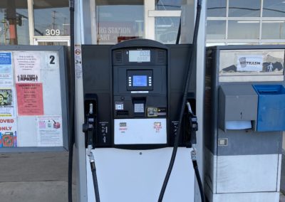 Photo of a fuel pump in front of a convenience store