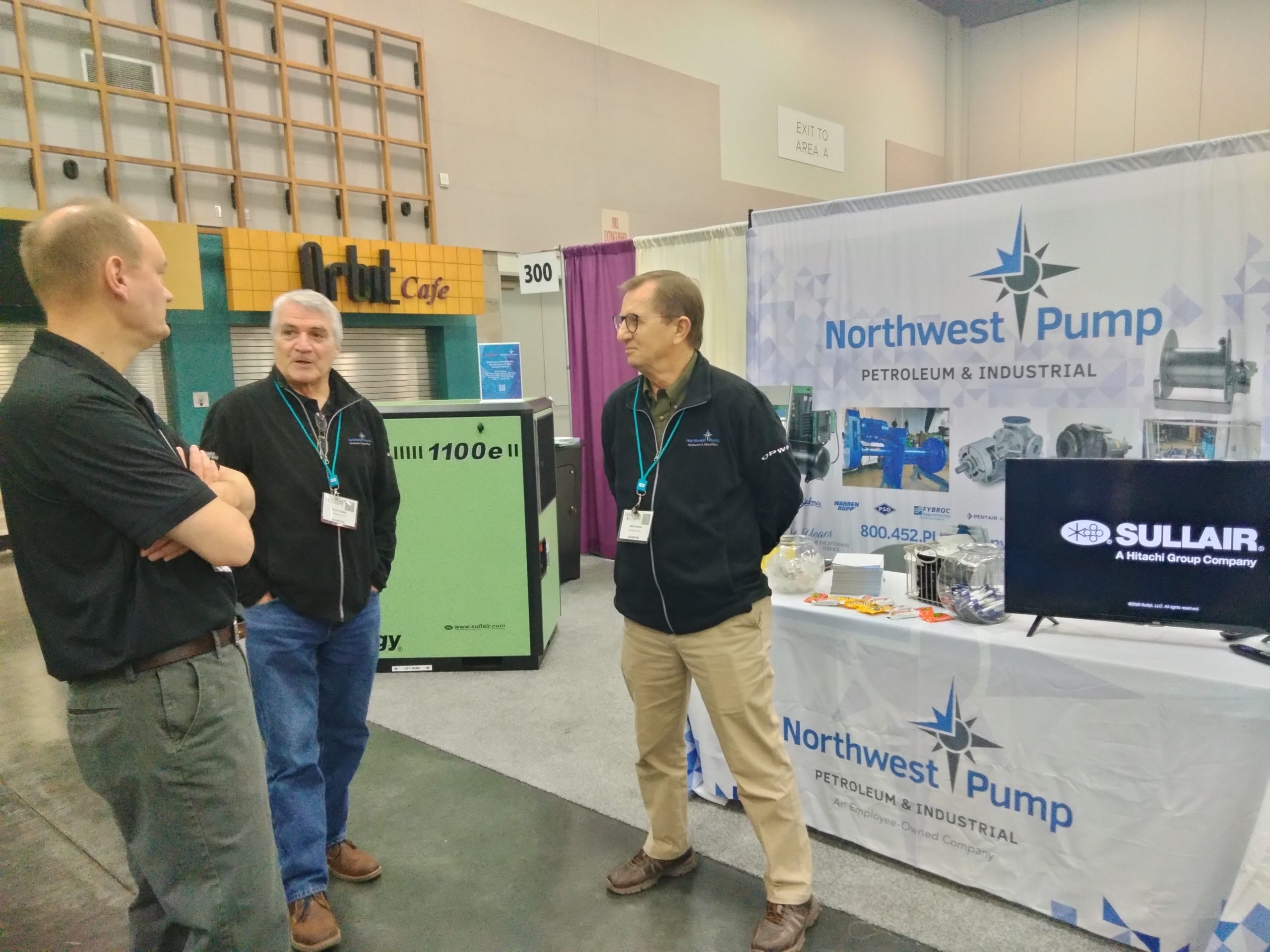 Northwest Pump's convention display and two NW Pump representatives