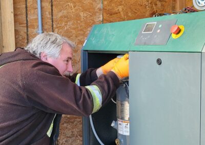 Technician servicing a Sullair air compressor