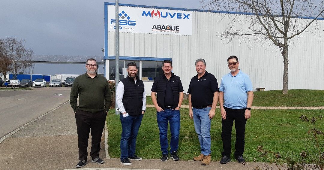 Mouvex and Northwest Pump representatives outside a warehouse