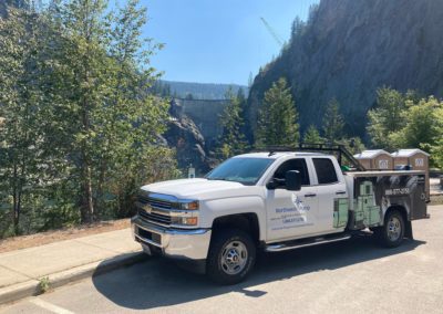 A Northwest Truck work truck parked in front of a dam