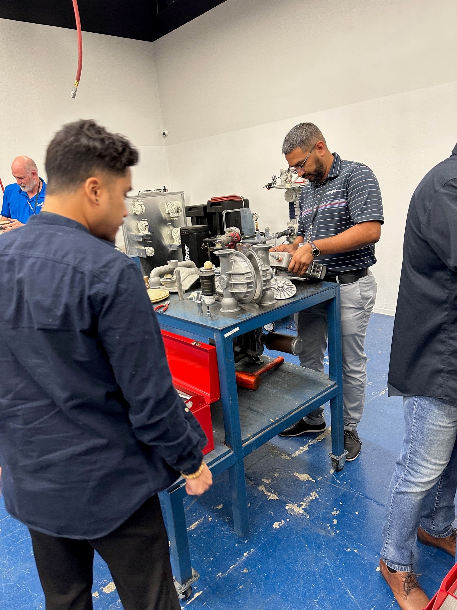 Technicians receiving hands-on training on how to repair fuel pumps