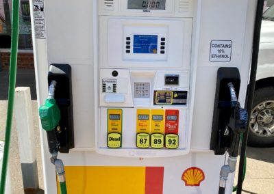Close up photo of a Shell station fuel pump