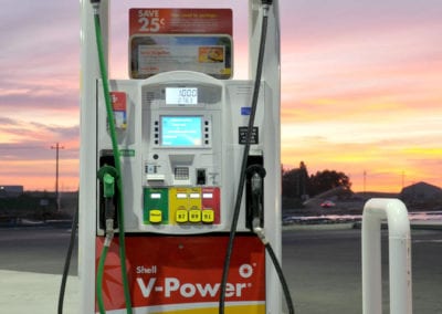 Photo of a Shell Station's fuel pumps at sunset