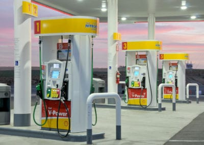 Photo of a Shell Station's fuel pumps at sunset